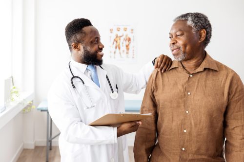 Senior man at a physical exam with his doctor.
