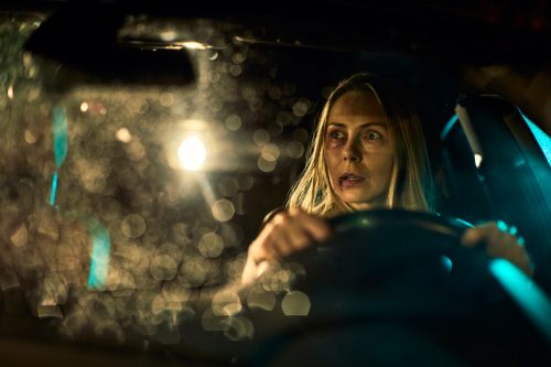 Close up of a injured and scared woman driving a car