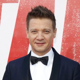 A headshot of Jeremy Renner wearing a tuxedo at a red carpet event