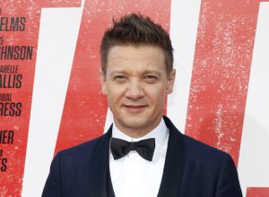 A headshot of Jeremy Renner wearing a tuxedo at a red carpet event