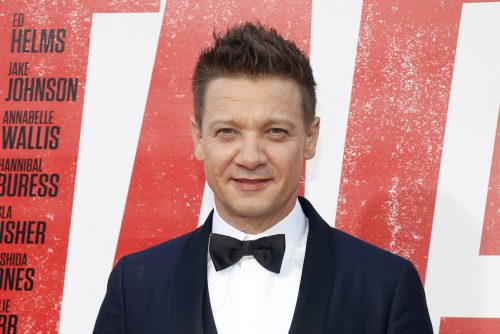 A headshot of Jeremy Renner wearing a tuxedo at a red carpet event