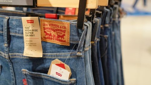 Close up of the waists of Levi's jeans hanging in a store