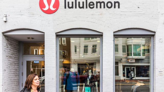 A Lululemon storefront with a customer exiting