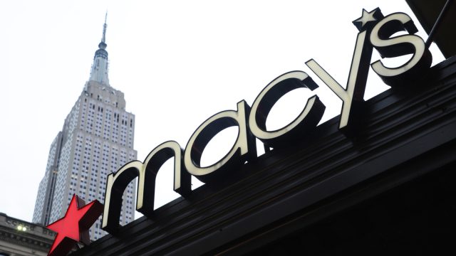 A Macy's sign with the Empire State Building in the background