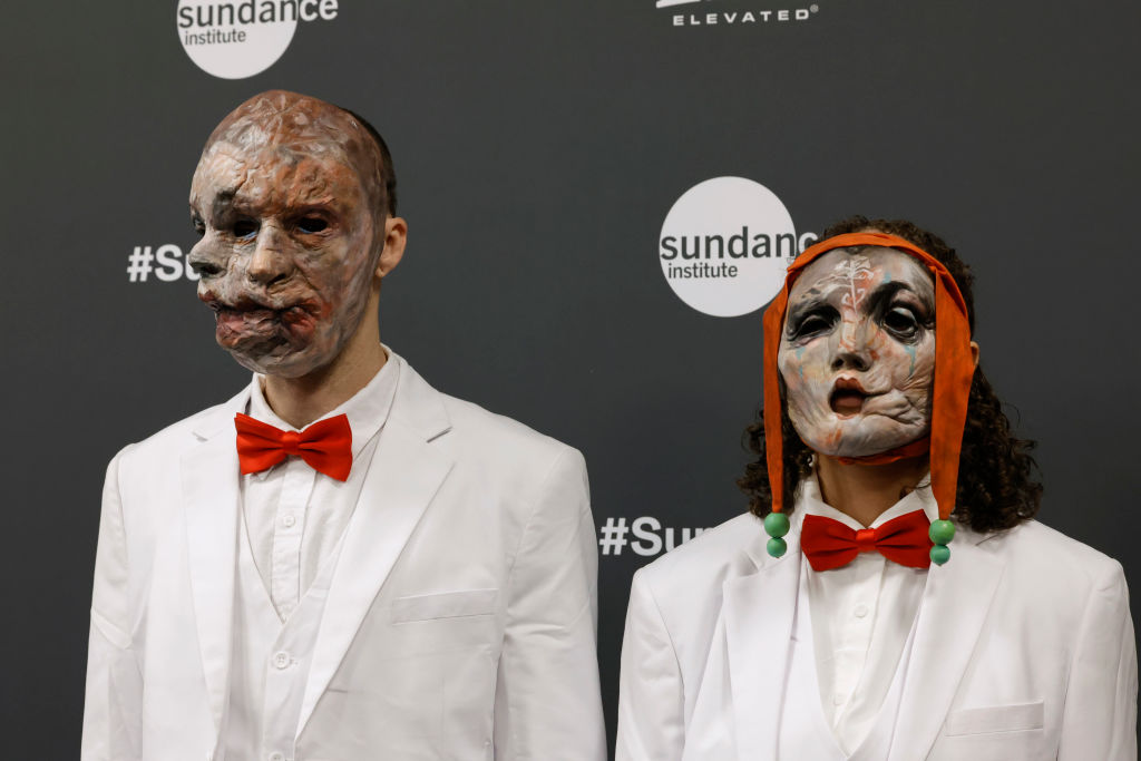 Two masked figures on the red carpet for the premiere of Infinity Pool at the Sundance Film Festival