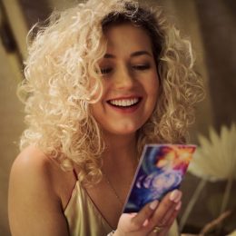 beautiful young blonde woman reading tarot