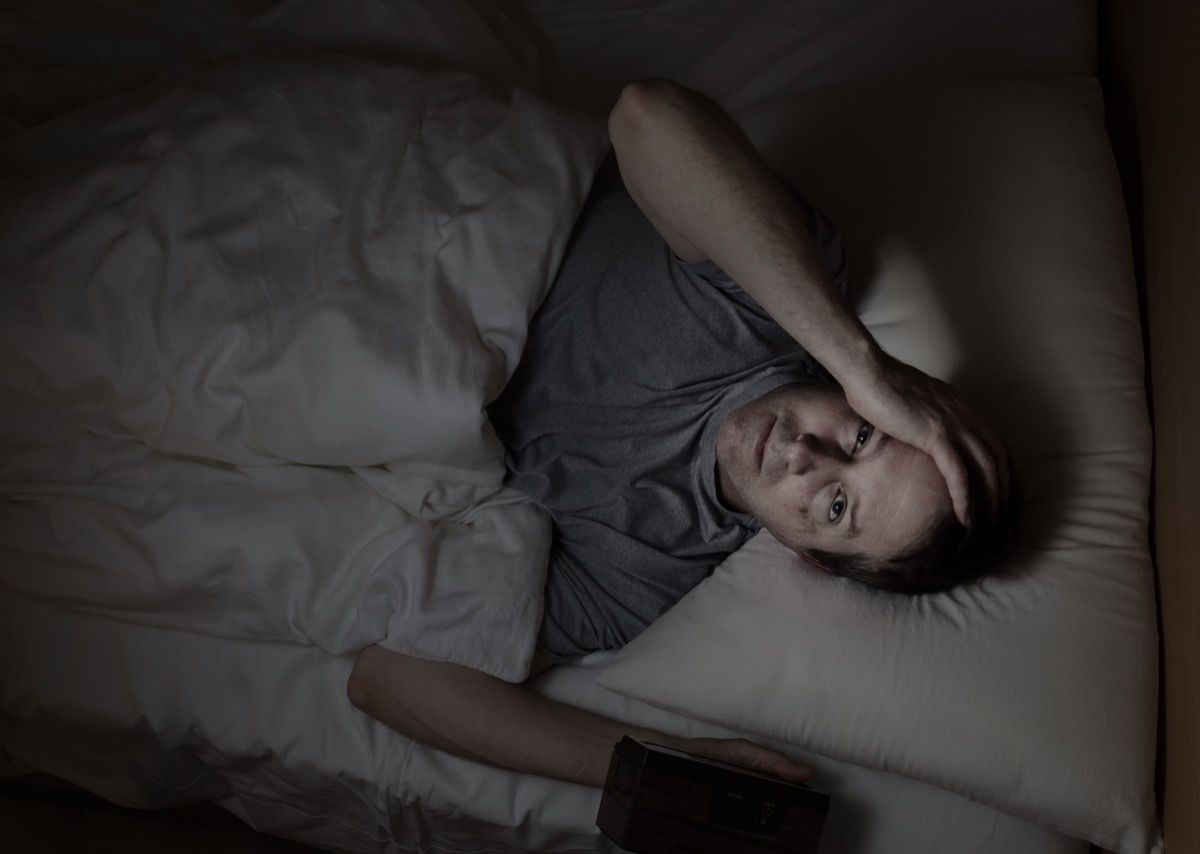 Top view image of mature man, looking forward, having trouble sleeping from insomnia