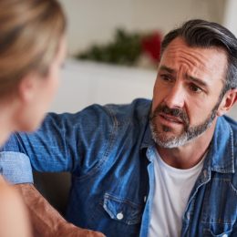 man looking concerned while talking to the woman across from him