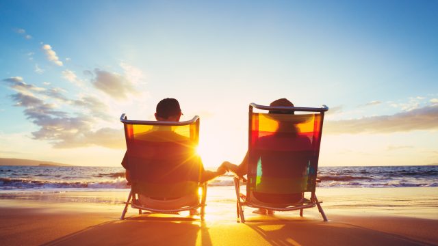 retired couple enjoying time on the beach