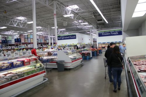 shoppers in the meat and dairy section of Sam's Club