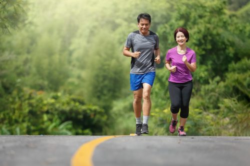 middle-aged couple running together