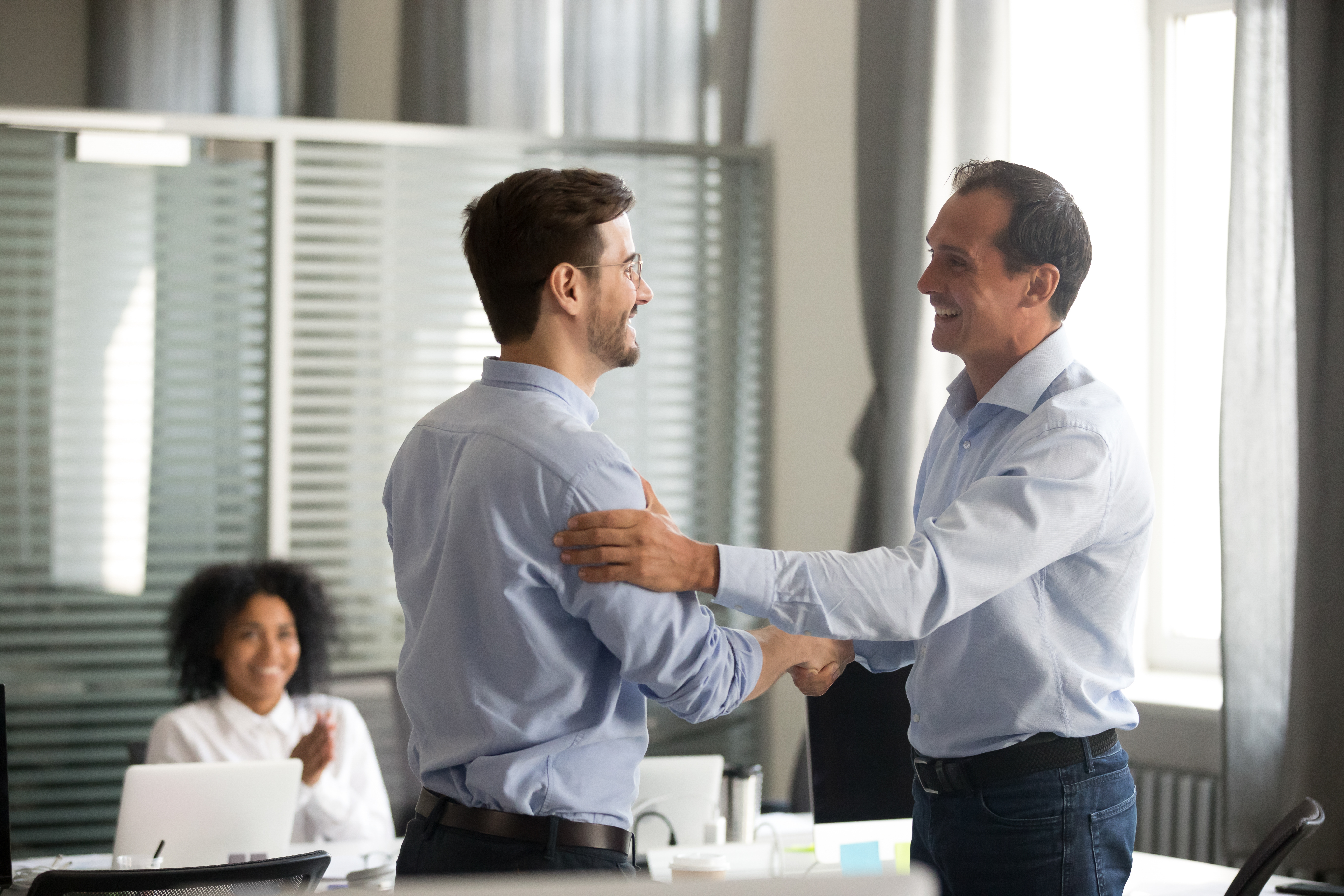 man thanking his boss in the office for mentorship