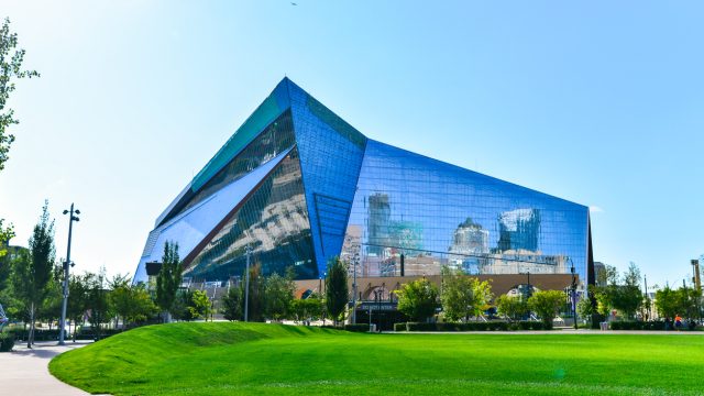 The exterior of US Bank Stadium in Minneapolis with green grass in front of it