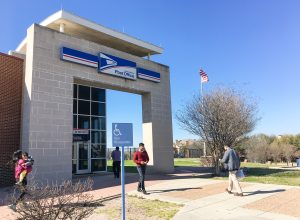Entrance of USPS store with customers. The United States Postal Service is an independent agency of US federal government for providing postal service national wide