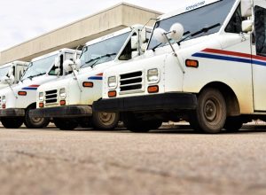 Tecumseh, Michigan, USA, November 20, 2021 U.S. Postal Service trucks in a line at Post Office before beginning mail deliveries.