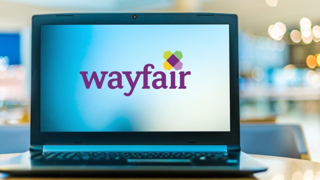 A laptop with the Wayfair logo on the screen
