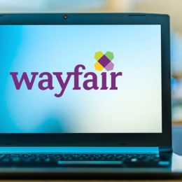 A laptop with the Wayfair logo on the screen