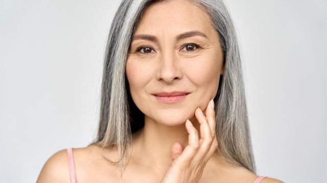 Closeup portrait of gorgeous middle aged mature asian woman with gray hair