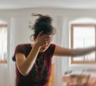 Blurred photo of a woman suffering from headache or stroke