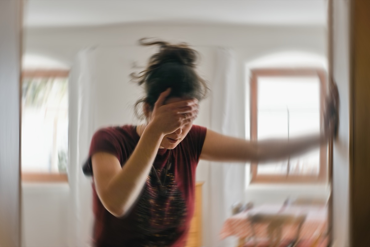 Blurred photo of a woman suffering from headache or stroke