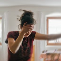 Blurred photo of a woman suffering from headache or stroke