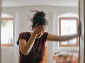 Blurred photo of a woman suffering from headache or stroke