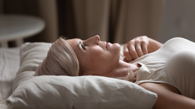 older woman lying in bed