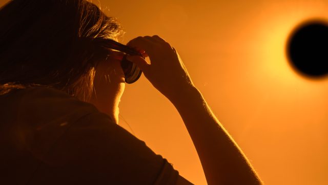 A woman using special glasses to watch a solar eclipse