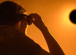 A woman using special glasses to watch a solar eclipse