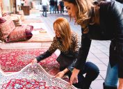 Two women looking at a rug in a store