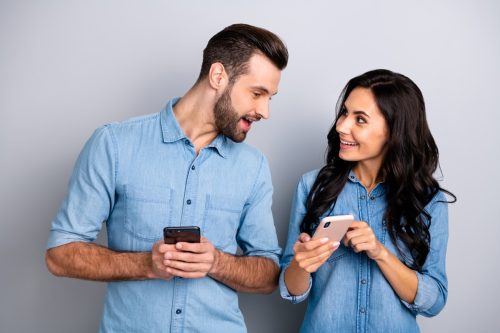 Two People Looking at Each Other's Phones