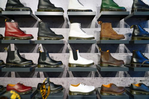 A wall display of Dr. Martens boots in a store