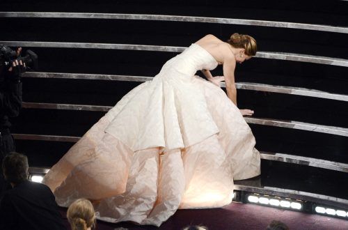 Jennifer Lawrence falling as she accepts her Oscar award.