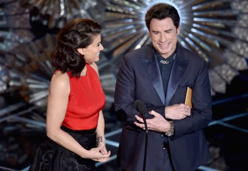 John Travolta and Idina Menzel on stage at The Oscars