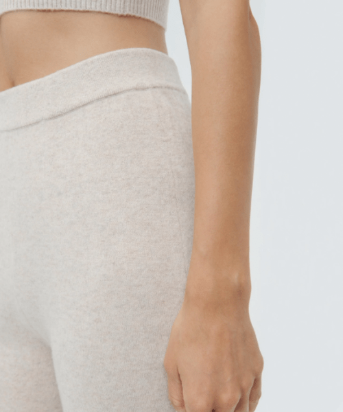 Close up product shot of Naadam's cropped cashmere pants in the oatmeal color.