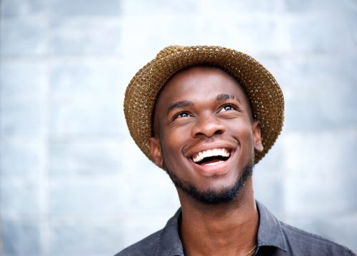 Man in a fedora hat smiling