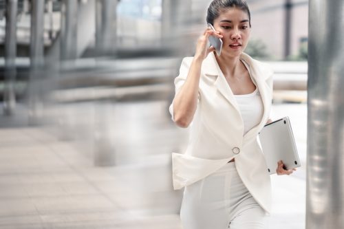 business woman in white running to her meeting.