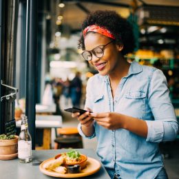 Young Black Woman Taking Picture of Food