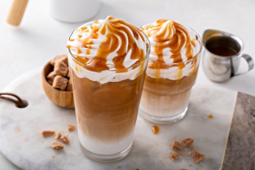 Iced caramel lattes topped with whipped cream and caramel sauce