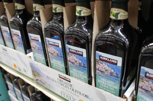 A view of several containers of Kirkland Signature organic extra virgin olive oil.