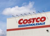 A close crop of a Costco sign on the side of a warehouse location