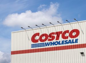 A close crop of a Costco sign on the side of a warehouse location
