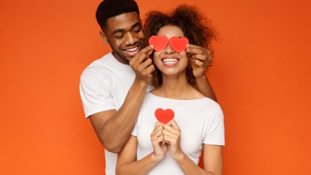 Couple in love holding cutout hearts