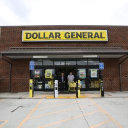 The customers exiting Dollar General with carts full of items