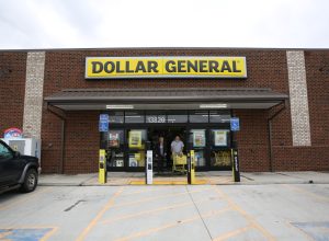 The customers exiting Dollar General with carts full of items