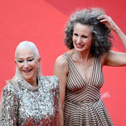 Helen Mirren and Andie MacDowell hand-in-hand on a red carpet