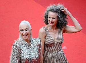 Helen Mirren and Andie MacDowell hand-in-hand on a red carpet