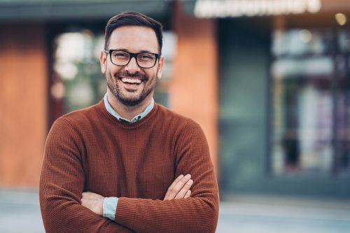 Portrait of a smiling man wearing a crewneck sweater