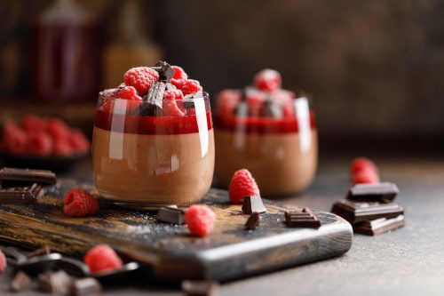 Chocolate panna cotta with raspberry jelly, raspberries and chocolate pieces