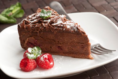 A piece of chocolate and raspberry torte on a plate